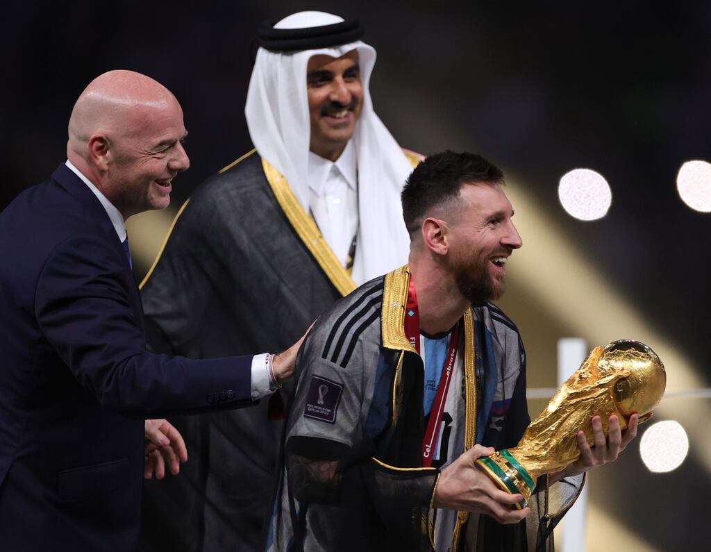 Argentina's Lionel Messi next to Emir of Qatar Tamim bin Hamad Al Thani and Fifa president Gianni Infantino during the trophy ceremony. Photograph: EPA