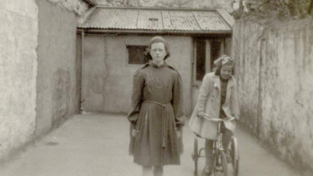 Ethel Corduff in her Irish dancing costume and her sister Gloria on the tricycle she won