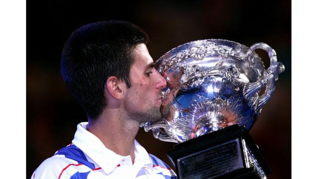 Novak Djokovic of Serbia kisses the Norman Brookes Challenge Cup after winning his men's final match against Andy Murray on day 14 of the 2011 Australian Open at Melbourne Park. - (Photograph: Ryan Pierse/Getty Images)