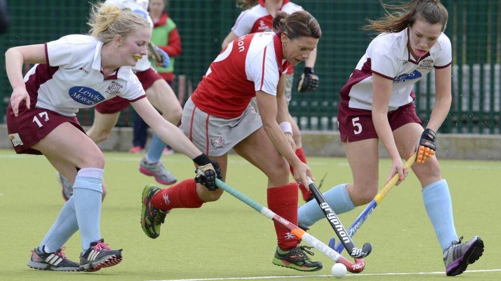 Claire McMahon of Pegasus is challenged by Hannah Matthews and Sinead McGirr of Loreto during their Irish Hockey League game in Queens University Belfast. Photograph: Rowland White/Presseye/Inpho