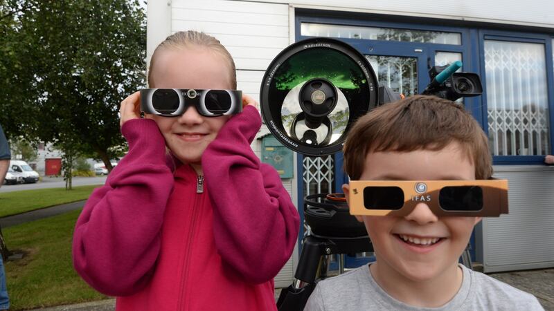 Eva and Flinn Bracken, from Swords, at Astronomy Ireland headquarters in Blanchardstown for the partial solar eclipse. Photograph: Cyril Byrne/The Irish Times
