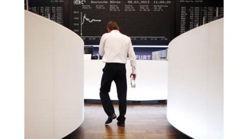 A trader makes his way in front of the German share price index DAX board at the German stock exchange in Frankfurt. photograph: Lisi Niesner/Reuters.