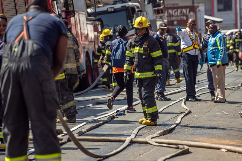 Firefighters at the scene of one of the deadliest residential fires in South Africa’s history. Photograph: Joao Silva/The New York Times