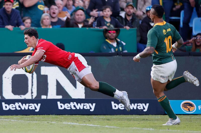 Wales' wing Louis Rees-Zammit dives to score the team's first try as South Africa's outhalf Elton Jantjies looks on during the first Test at Loftus Versfeld in Pretoria. Photograph: Phill Magakoe/AFP via Getty Images