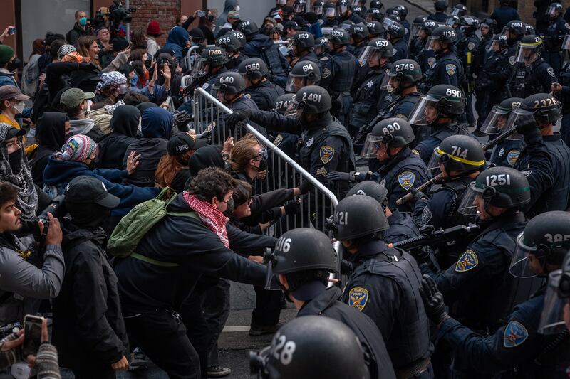 Protesters confront police near a US Immigration and Customs Enforcement facility in San Francisco. Photograph: Loren Elliott/The New York Times