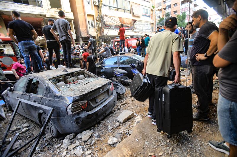 People look on at the damage following the strike in Beirut on Friday. Photograph: AFP via Getty