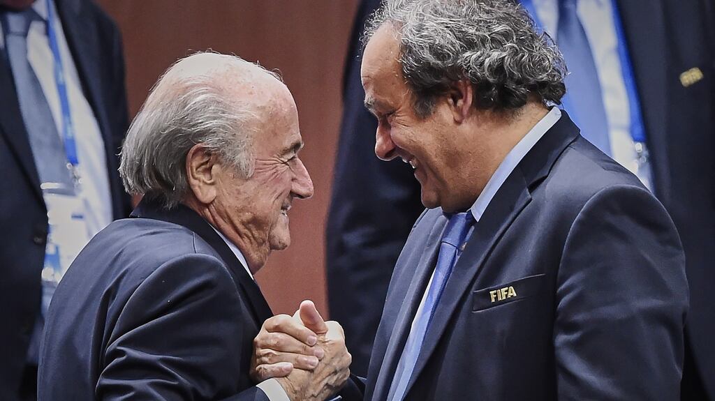 Old pals -former Eufa president Sepp Blatter shakes hands with his protege Michel Platini. Photograph: Michael Buholzer/ AFP’Getty