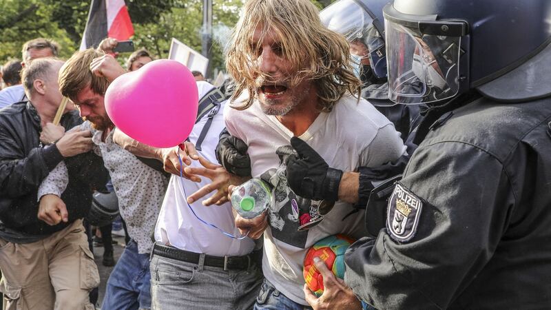 German riot police detain a protester as coronavirus sceptics and right-wing extremists march in Berlin in protest against coronavirus-related restrictions. Photograph: Getty