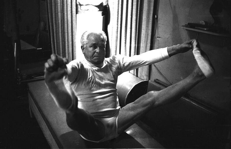 NEW YORK - OCTOBER 1961: Joe Pilates, Inventor, physical fitness guru and founder of the Pilates exercise method demonstrates his techniques in his 8th Avenue studio on October 4, 1961 in New York City, New York. (Photo by IC Rapoport/Getty Images)