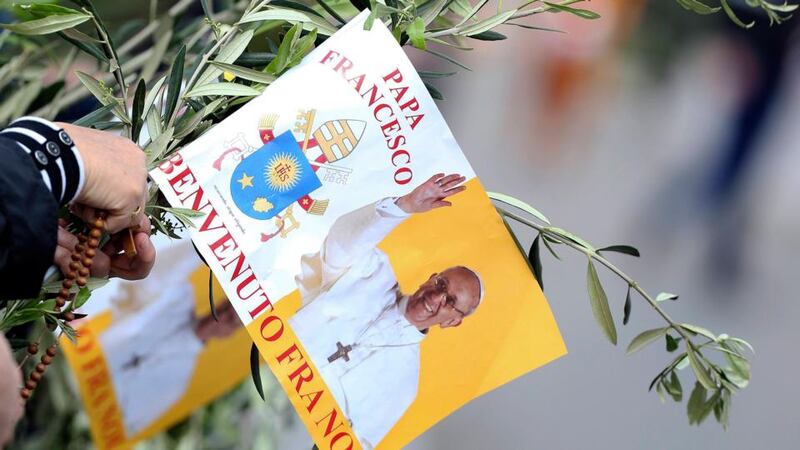 A worshipper holds a flag with a picture of Pope Francis in Saint Peter’s Square at the Vatican. Photograph: Alessandro Bianchi/Reuters