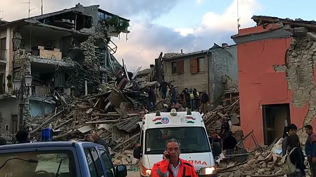 Rescuers search a collapsed building in Amatrice, central Italy on Wednesday. Photograph: AP