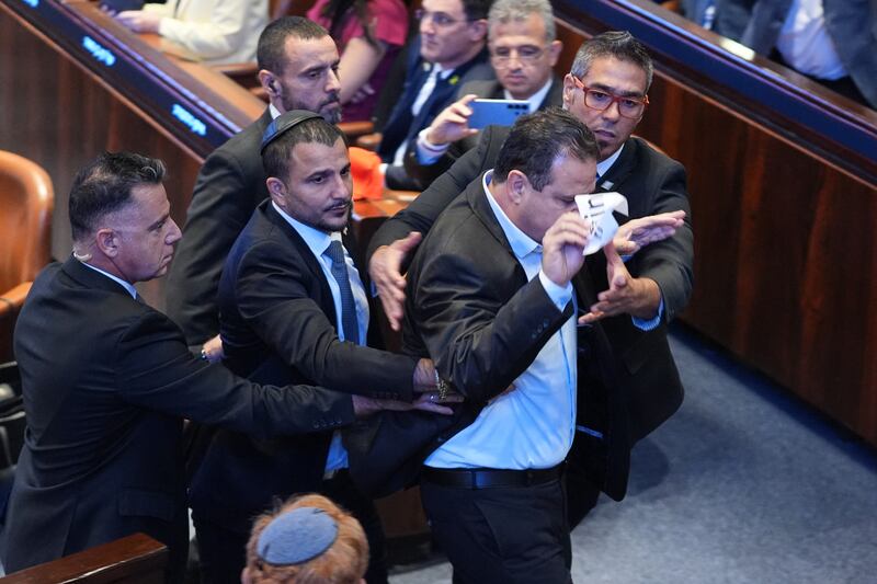 Israeli lawmaker Ayman Odeh is escorted from the Knesset after holding a sign reading 'Recognise Palestine'. Photograph: Evan Vucci/'Getty