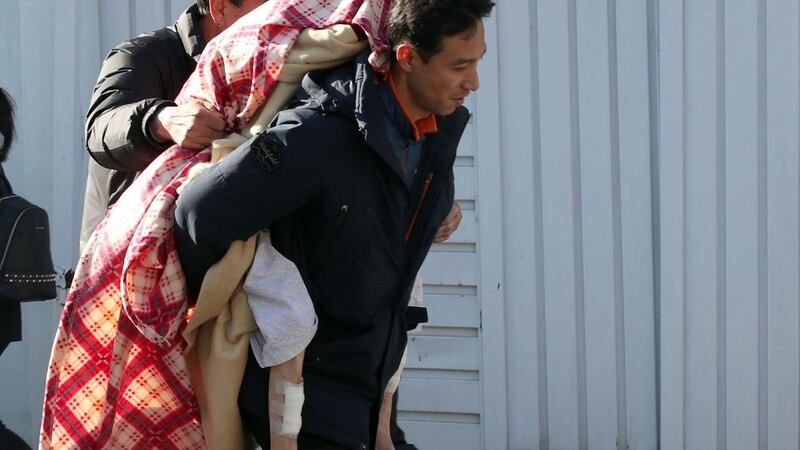 A man carries a patient from the scene after a fire broke out at a hospital in Miryang on January 26th, 2018. Photograph: AFP/Getty Images