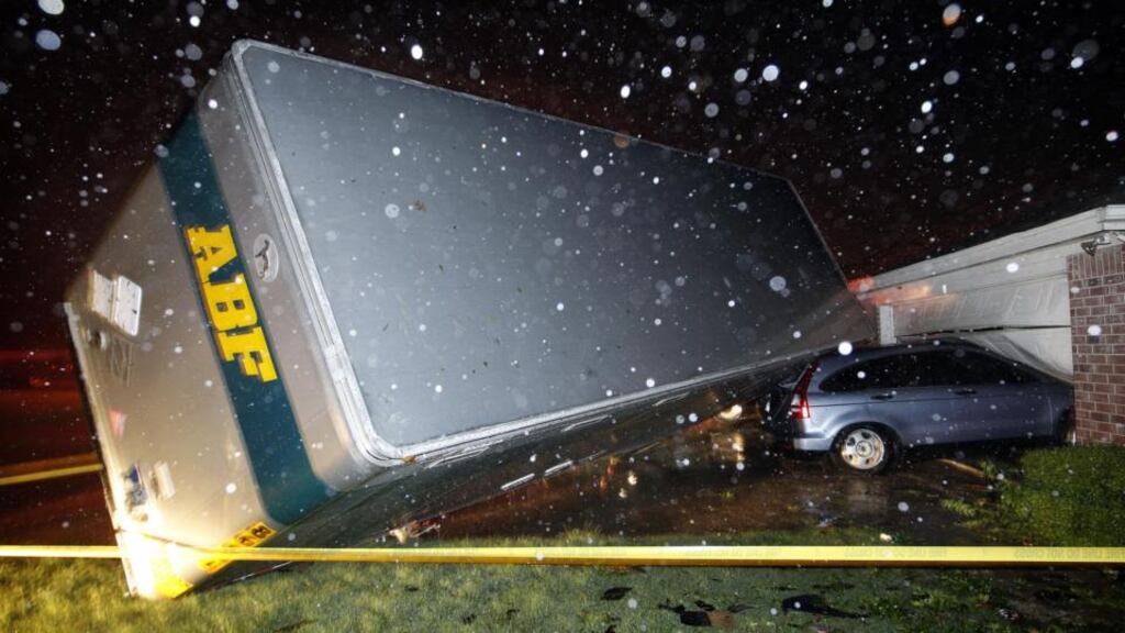 A trucking company trailer landed on a car that was parked in front of a home in Cleburne, Texas, after a powerful storm last night. Neighbours say the trailer was parked on the street and was rolled over on to the car. Photograph: Tom Fox/AP Photo/The Dallas Morning News