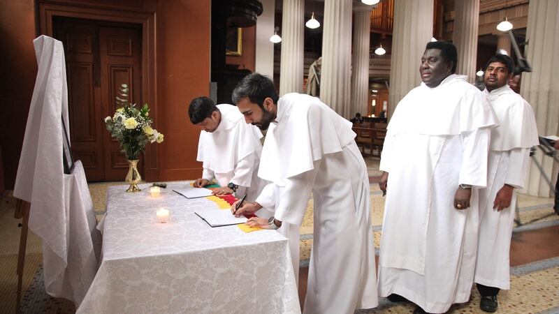 Br Simon, Br Barry, Br Raj and Br Theiva from the Presentation Brothers signing the book of condolence before the Mass to remember the victims of the Sri Lanka bombings. Photograph: John McElroy