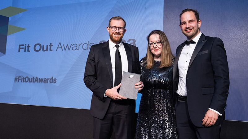 Clare Healy, head of design at The Interiors Group, presents the fit out project management firm of the year award to Stephen Grant and Chris Horton, Turner & Townsend