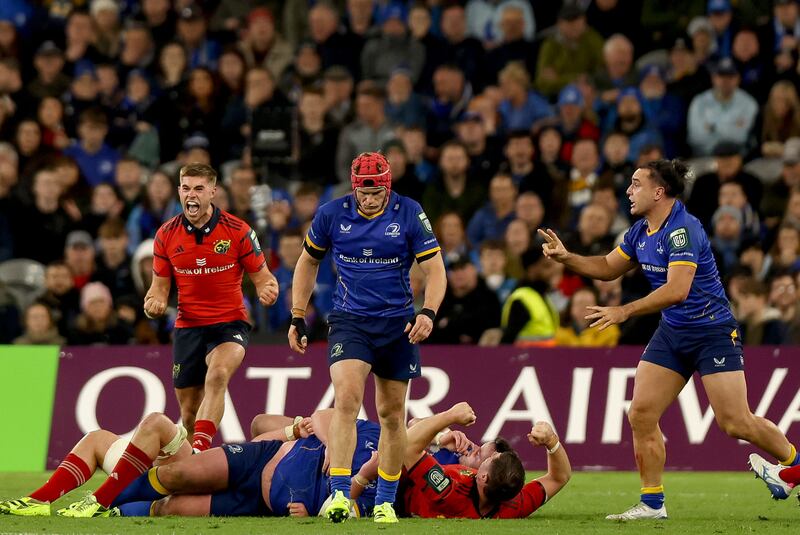 Munster's Jack Crowley celebrates referee’s decision whilst Josh van der Flier and James Lowe of Leinster are left dejected. Photograph: INPHO/ Tom Maher