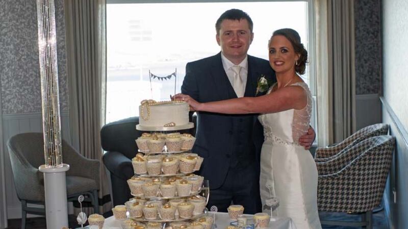 The bride and groom cutting their wedding cake