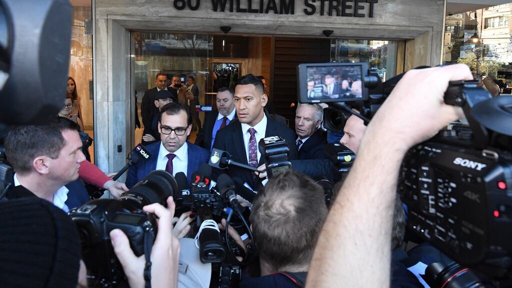 Israel Folau (C) leaves a conciliation hearing at the Fair Work Commission in Sydney, New South Wales. Photo: Peter Rae/EPA