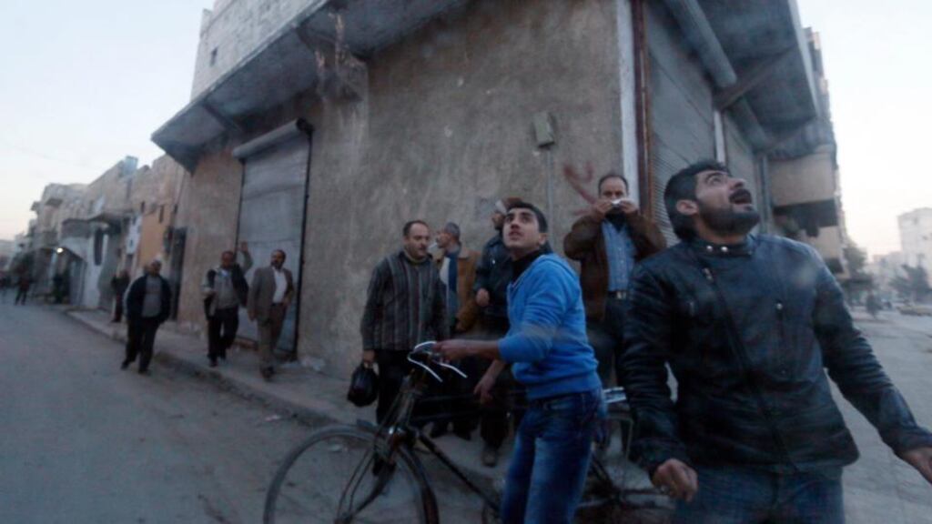 Residents react during what activists said was an air raid by forces loyal to Syrian president Bashar Al-Assad on Aleppo over the weekend. Photograph: Reuters/Saad Abobrahim