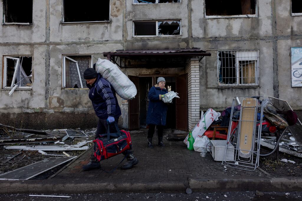 People carry surviving items from a damaged residential building following a strike in Dobropillia, Donetsk region, Ukraine. Photograph: Getty Images