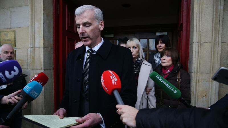 Solicitor Liam Keane reads out a statement on behalf of Clodagh Hawe’s mother Mary Coll (right) and sister Jacqueline Connelly (third right) outside Cavan Court House. Photograph: PA