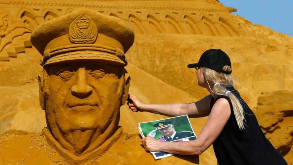 Sand sculptor Irina Sokolova works on a portrait of Belgian King Albert II during the sand sculpture festival in Blankenberge, northern Belgium. Photograph: Reuters/Yves Herman