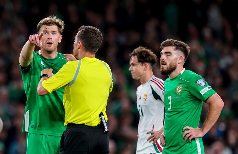 Nathan Collins speaks to referee Harm Osmers. Photograph: Ryan Byrne/Inpho