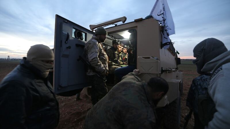 Opposition fighters gather around a vehicle near al-Tabanah during ongoing battles with government forces in Syria’s Idlib province on January 11th, 2018.  Photograph: Omar Haj Kadour/AFP/Getty Images