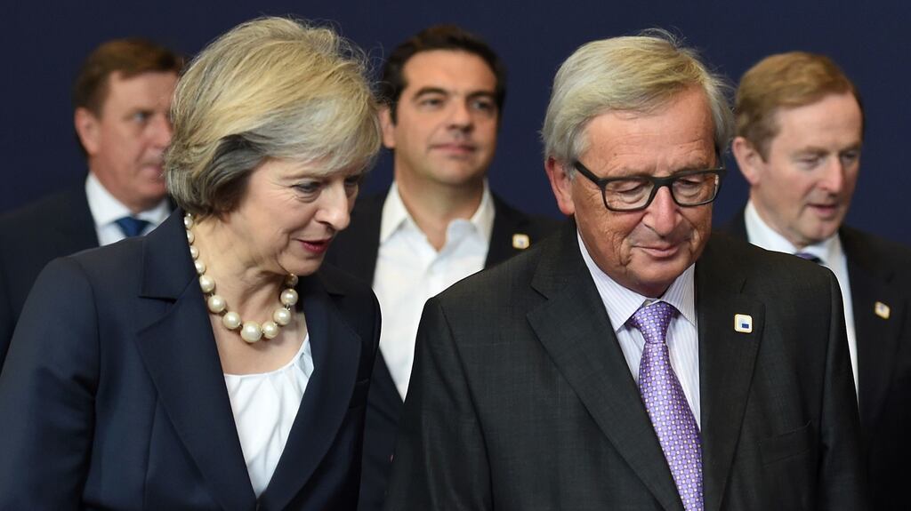 British prime minister Theresa May talks with European Commission president Jean-Claude Juncker at the European Union leaders summit in Brussels also attended by Taoiseach Enda Kenny, seen on the right. Photograph: Stephane de Sakutin/AFP/Getty Images