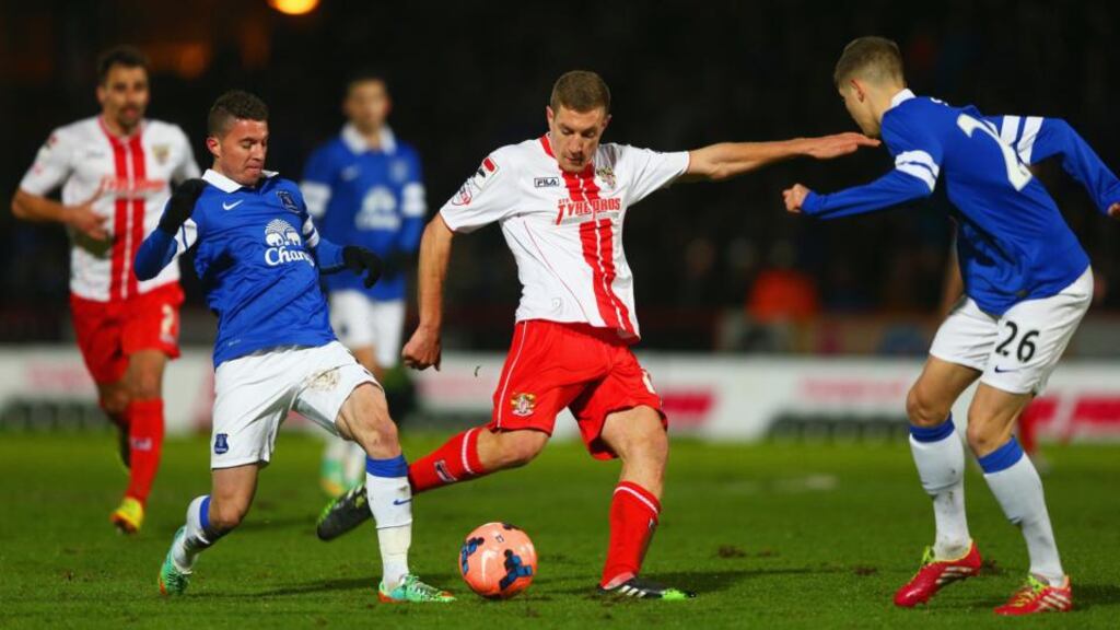 Everton’s Bryan Oviedo challenges Simon Heslop of Stevenage as he attempts a shot during the FA Cup fourth-round clash at the Lamex Stadium. Oviedo suffered a broken leg during the incident. Photograph: Paul Gilham/Getty Images