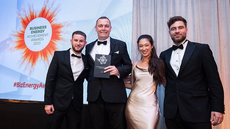 Adam Kane, senior sales executive at BusinessRiver, presents best energy achievement in public sector award to An Post team