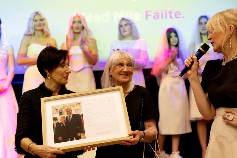 Deirdre Fraser, wife of Ireland's Ambassador to Britain, Martin Fraser, makes a presentation to Margaret Curran, with Siobhan Reynolds as MC, at the elders fashion show at the Irish Cultural Centre in Hammersmith. Photograph: Noel Mullen
