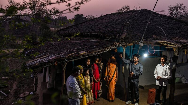 Vinod Patil, arm raised, a Pentecostal preacher, prays for a family at their home in the state of Madhya Pradesh. Photograph: Atul Loke/New York Times