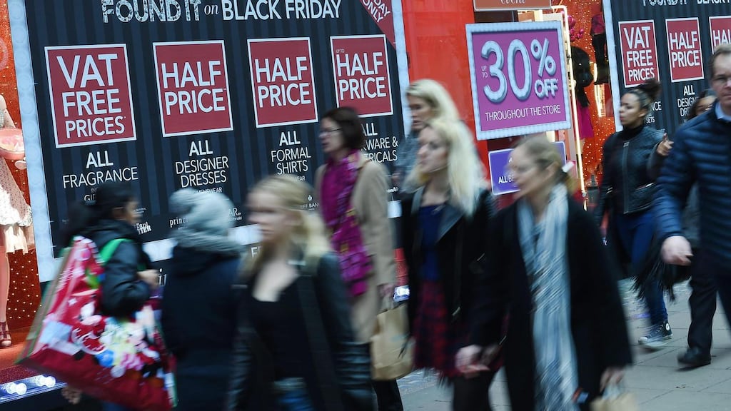 Shoppers pass a store offering Black Friday sales on Oxford Street in London, Britain. Police have been called to various supermarkets across Britain after chaos broke out during ‘Black Friday’ late night shopping. Photo: EPA/ANDY RAIN