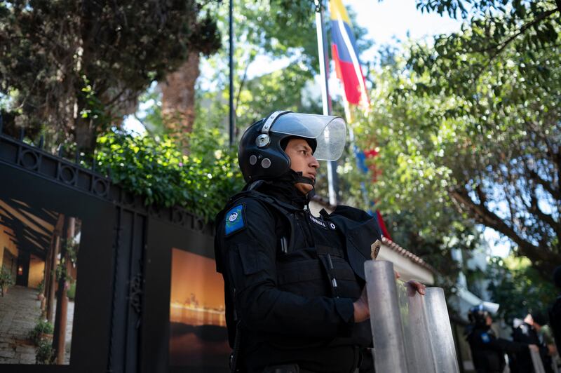 Riot police officers and members of the diplomatic police corps stand guard outside the Ecuadorian embassy in Mexico City. Photograph: Yuri Cortez/Getty Images