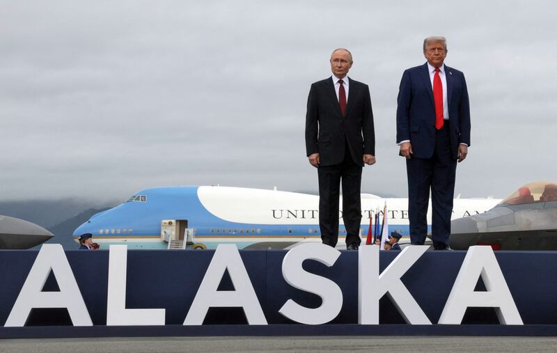 US president Donald Trump and Russian president Vladimir Putin stand on a platform announcing their summit in Alaska at Joint Base Elmendorf-Richardson. Photograph: Gavriil Grigorov/Pool/AFP via Getty Images