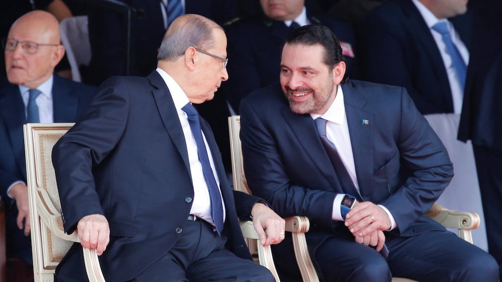 Saad Hariri (right), who announced his resignation as Lebanon’s prime minister from Saudi Arabia, talks with Lebanese president Michel Aoun at a military parade to celebrate the 74th anniversary of Lebanon’s independence in Beirut on Wednesday. Photograph: Mohamed Azakir/Reuters