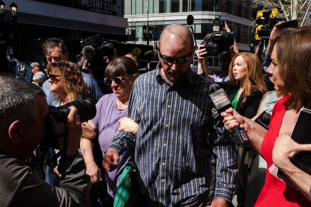 Thomas Dufault, stepfather of Pentagon leak suspect Jack Teixeira, and Dawn Dufault (centre), Mr Teixeira’s mother, are surrounded by media after leaving federal court on Friday. Federal prosecutors allege Mr Teixeira took secret documents from the Massachusetts air national guard base where he worked and posted them online. Photograph: Sophie Park/New York Times