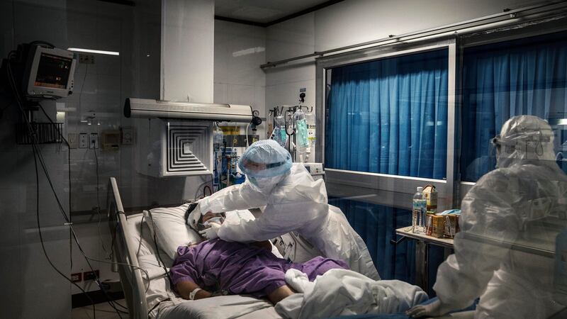 A nurse secures the mask of a Covid-19 patient in the intensive care section of a private hospital in Bangkok. Photograph: Adam Dean/The New York Times