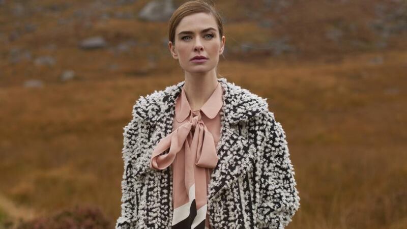 Sam wears long Chelsea coat, €249, Remus; scarf €25, Arnotts Collection; cable knit crew neck jumper €135, Fisherman Out of Ireland; cotton twill chinos €99, Magee.