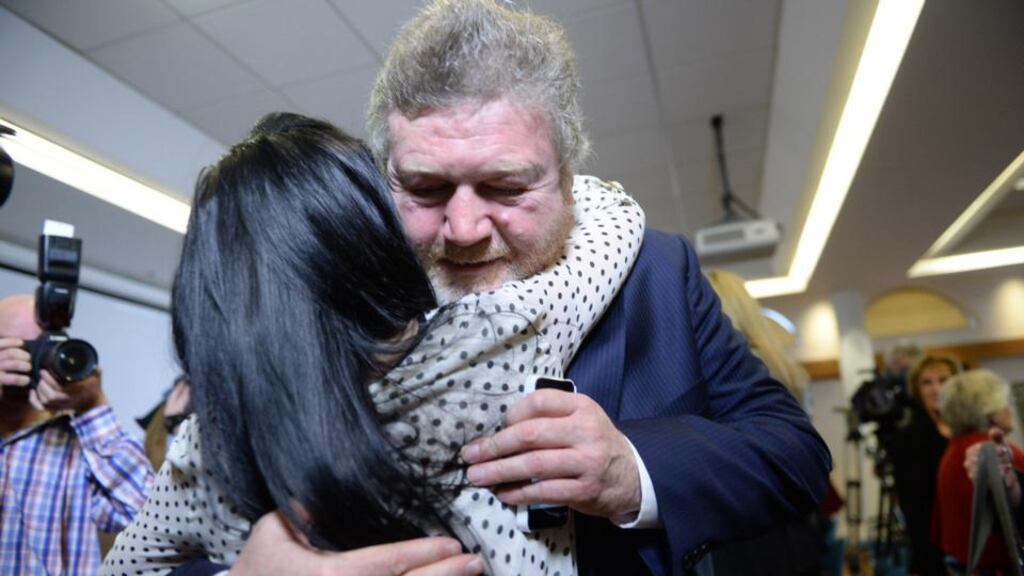 MInister for Health Dr James Reilly is hugged by Natasha Molyneaux, mother of Nathan, following the Department of Health press conference on the Midland Regional Hospital Portlaoise yesterday. Photograph: Cyril Byrne