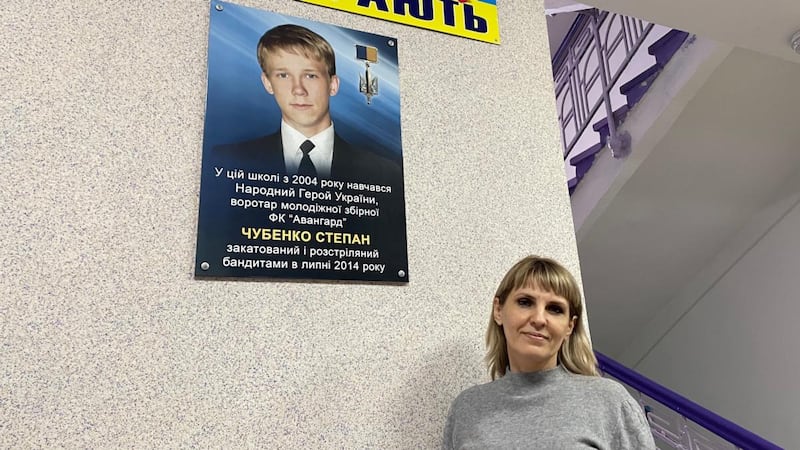 School head Olena Mironenko in Kramatorsk stands by a photo of former pupil Stepan Chubenko (16) who was shot dead in 2014 by pro-Russian separatists. Photograph: Daniel McLaughlin