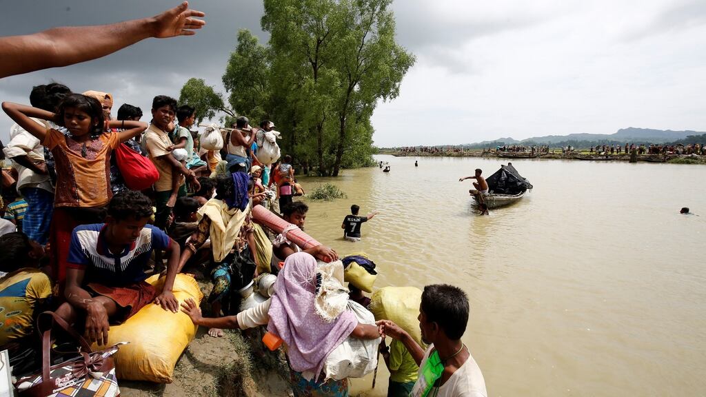 Rohingya refugees wait for boat to cross a canal after crossing the border through the Naf river in Teknaf, Bangladesh. Photograph: Reuters/Mohammad Ponir Hossain