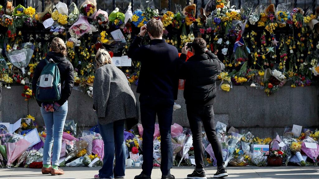People look at floral tributes left after the attack on the British parliament last month. Photograph: Reuters