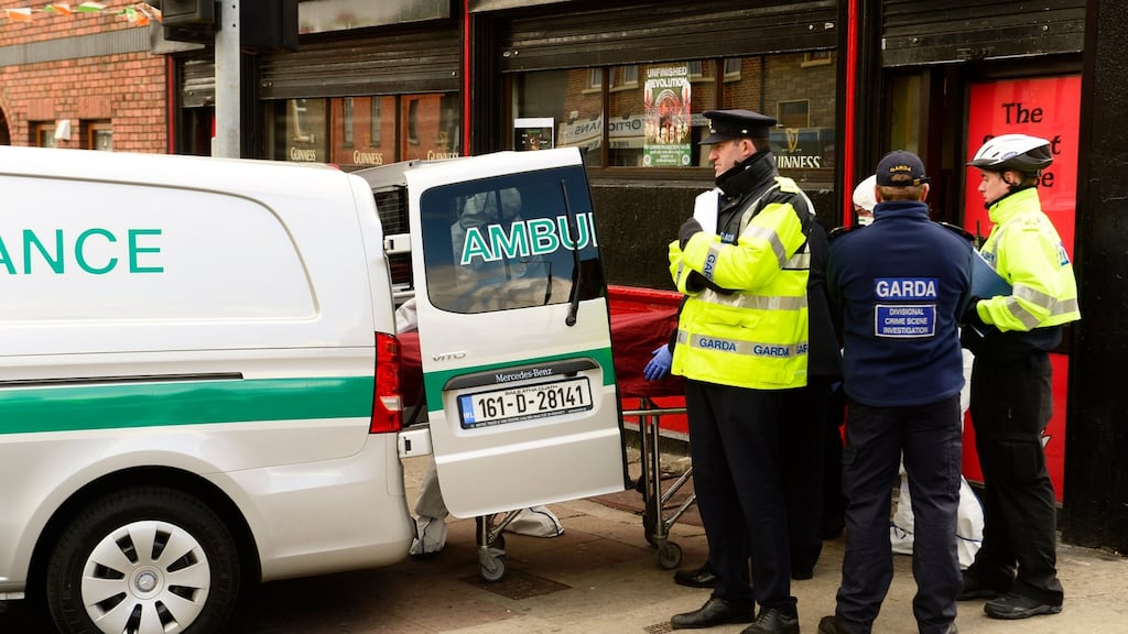 Gardaí and forensic teams remove a body from the scene of the shooting at Sunset House, Summerhill, this morning. Photograph: Cyril Byrne / The Irish Times