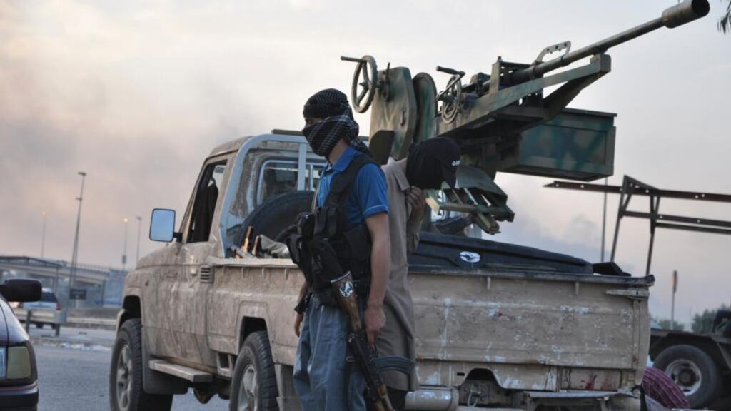 Isis fighters guard a checkpoint in the northern Iraqi city of Mosul. Photograph: Reuters