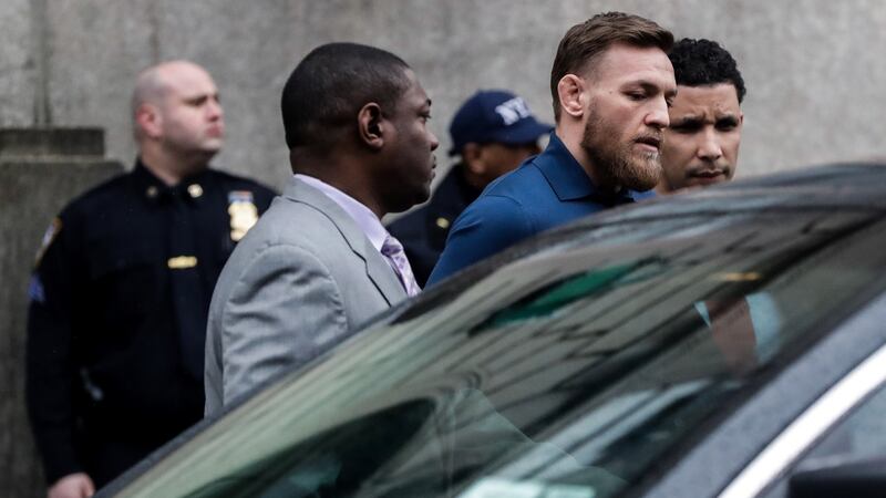 MMA fighter Conor McGregor walks out of the 78th police precinct in   the Brooklyn borough of New York City after charges were laid against him. Photograph:  Jeenah Moon/Reuters