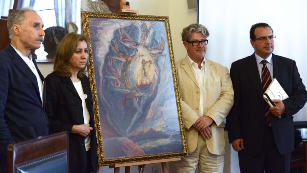 From left: Spanish artist Tomeu Lamo, Spanish art expert Carmen Sandalinas Linares, French Dali expert Nicolas Descharnes and Spanish art expert Jose Pedro Venzal Placido pose next to Salvador Dali’s “The Intrautirine Birth of Salvador Dali” during its presentation in Madrid. Photograph: Gerard Julien/AFP/Getty Images