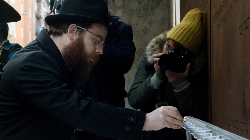 The head of the Hasidic Unified Hungarian Israelite Congregation (Emih), chief rabbi Slomo Koves, lights candles to commemorate the liberation of the Budapest Jewish ghetto in January 2017. Emih insists that it is “righteous” to try to retrieve Jewish remains from the Danube. Photograph: Szilard Koszticsak/EPA
